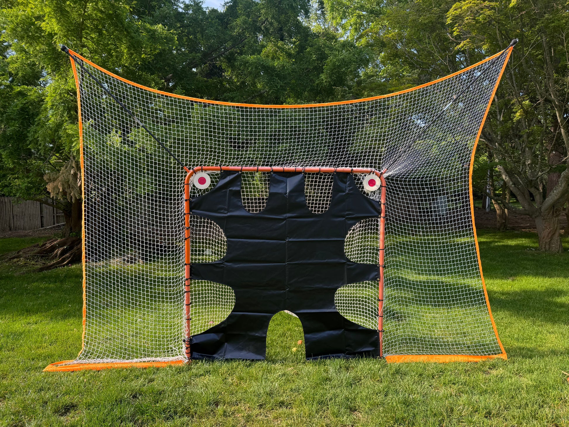 lacrosse goal net without removable black goal shield and shooting targets front view on grass