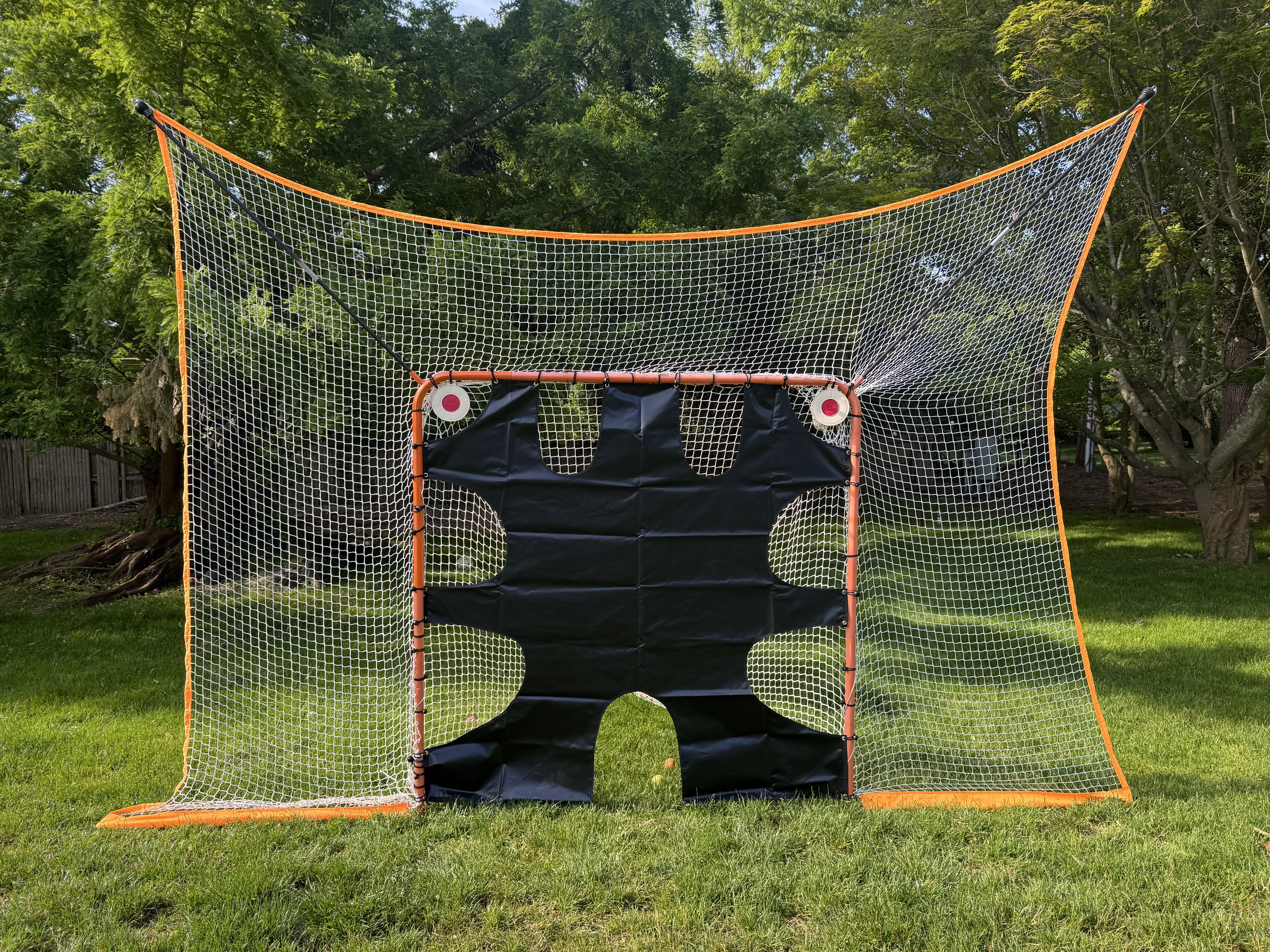 lacrosse goal net without removable black goal shield and shooting targets front view on grass