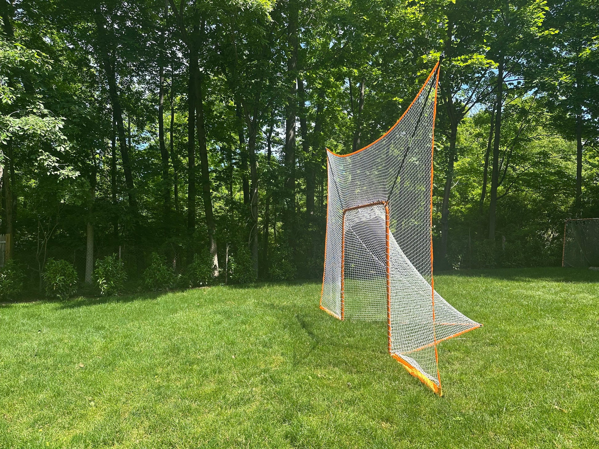 lacrosse goal net without removable black goal shield side view on grass