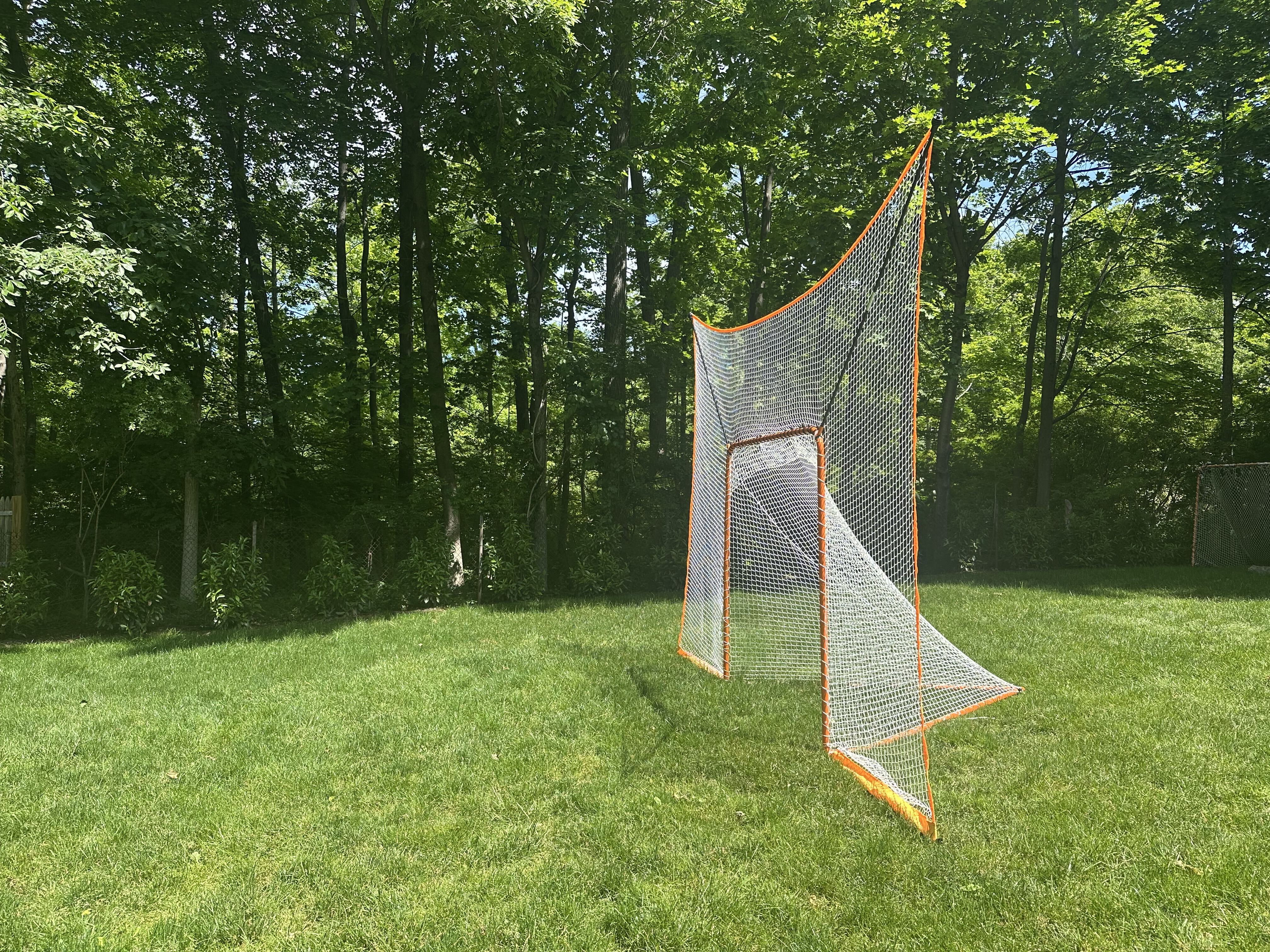 lacrosse goal net without removable black goal shield side view on grass