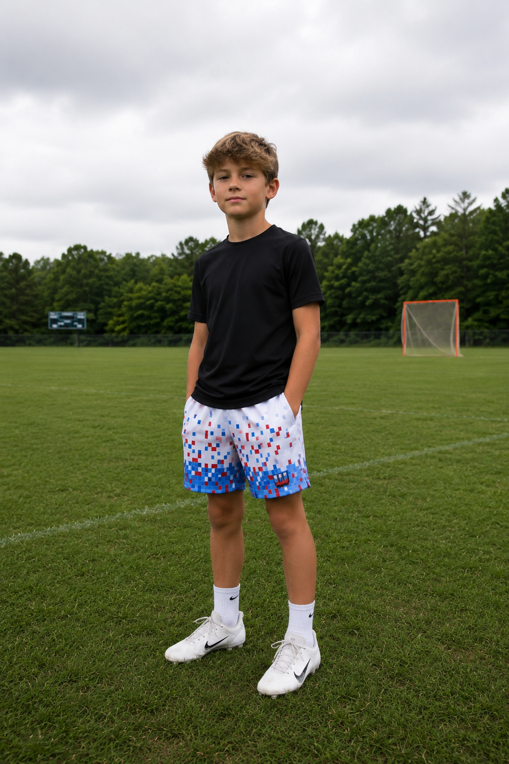 Youth athlete wearing Workplay pixel mesh shorts on lacrosse field 